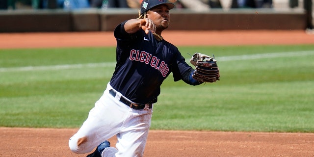 Cleveland Guardians third baseman Jose Ramirez throws from his knees to second base but is unable to get the force out on an infield single by Milwaukee Brewers' Pedro Severino during the third inning of a spring training baseball game Tuesday, March 29, 2022, in Goodyear, Ariz.