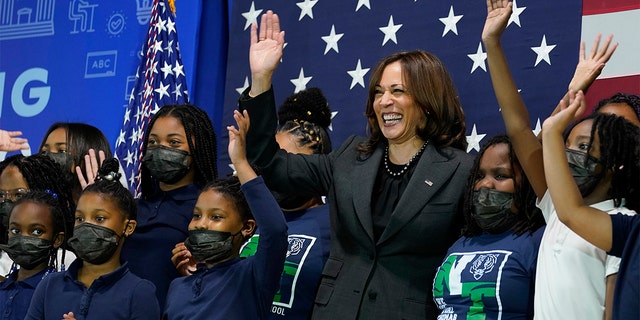 Vice President Kamala Harris poses for a photo with students at Thomas Elementary School in Washington, Monday, April 4, 2022. 