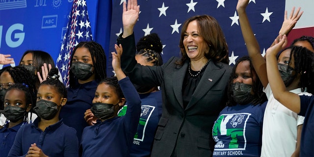 Vice President Kamala Harris poses for a photo with students at Thomas Elementary School in Washington, Monday, April 4, 2022.