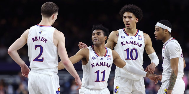 Christian Braun #2, Remy Martin #11, Jalen Wilson #10 and Dajuan Harris Jr. #3 of the Kansas Jayhawks react in the second half of the game against the Villanova Wildcats during the 2022 NCAA Men's Basketball Tournament Final Four semifinal at Caesars Superdome on April 02, 2022 in New Orleans, Louisiana. 