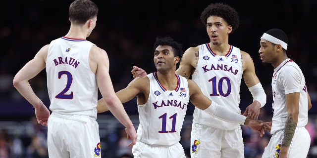 Christian Braun #2, Remy Martin #11, Jalen Wilson #10 and Dajuan Harris Jr. #3 of the Kansas Jayhawks react in the second half of the game against the Villanova Wildcats during the 2022 NCAA Men's Basketball Tournament Final Four semifinal at Caesars Superdome on April 02, 2022 in New Orleans, Louisiana. 