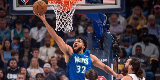 Timberwolves stun Grizzlies, grab Game 1 win 2 Minnesota Timberwolves center Karl-Anthony Towns (32) shoots ahead of Memphis Grizzlies center Steven Adams (4) during the first half of Game 1 of a first-round NBA basketball playoff series Saturday, April 16, 2022, in Memphis, Tenn.