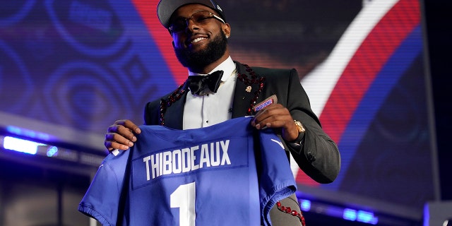 Oregon defensive end Kayvon Thibodeaux holds a jersey after being picked by the New York Giants during the NFL Draft Thursday, April 28, 2022, in Las Vegas.