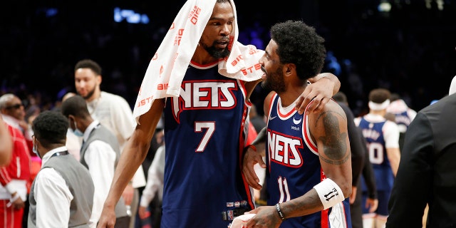 The Nets' Kevin Durant (7) talks with Kyrie Irving (11) after the second half against the Cleveland Cavaliers at Barclays Center April 8, 2022, in Brooklyn.