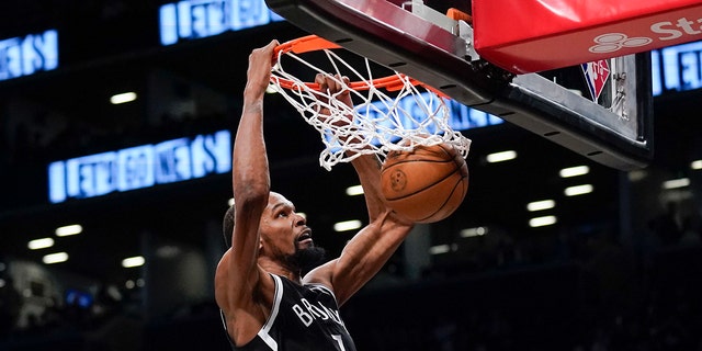 The Brooklyn Nets' Kevin Durant dunks the ball during the second half of the opening game of the NBA play-in tournament against the Cleveland Cavaliers April 12, 2022, in New York.