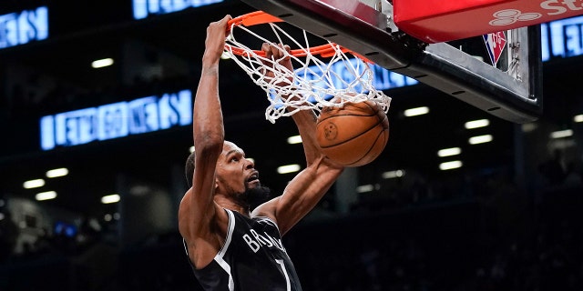 Brooklyn Nets' Kevin Durant dunks the ball during the second half of the opening basketball game of the NBA play-in tournament against the Cleveland Cavaliers, Tuesday, April 12, 2022, in New York.