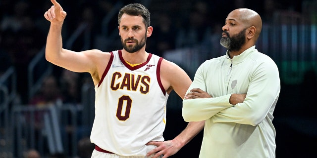 Kevin Love talks with Head coach J.B. Bickerstaff of the Cleveland Cavaliers during the first quarter against the Orlando Magic at Rocket Mortgage Fieldhouse on March 28, 2022 in Cleveland, Ohio.