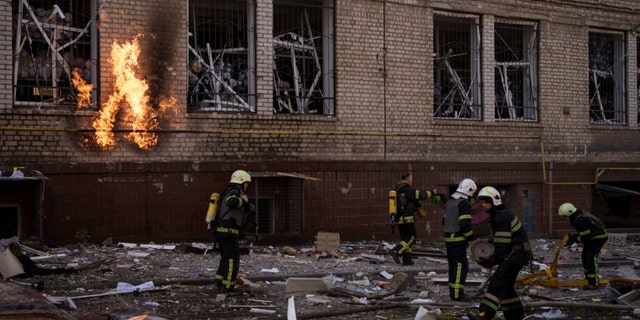 Firefighters work to extinguish multiple fires after a Russian attack in Kharkiv, Ukraine, Saturday, April 16, 2022. 