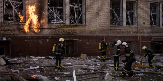 Firefighters work to extinguish multiple fires after a Russian attack in Kharkiv, Ukraine, Saturday, April 16, 2022.