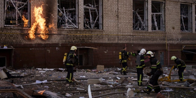 Firefighters work to extinguish multiple fires after a Russian attack in Kharkiv, Ukraine, Saturday, April 16, 2022. 