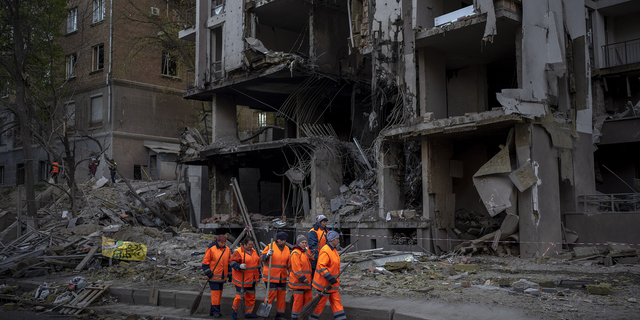 Cleanup crews prepare to work Friday, April 29, at the site of an explosion in Kiev, Ukraine. 