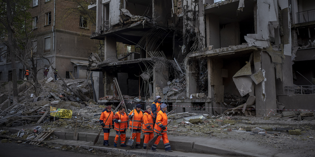 Clean-up crews prepare to work on Friday, April 29 at the site of an explosion in Kyiv, Ukraine. 