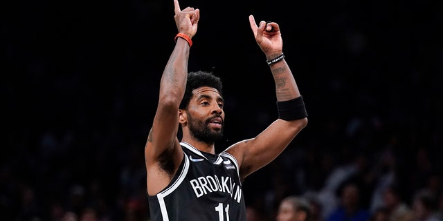 Brooklyn Nets' Kyrie Irving reacts after sinking the basket in the second half of the opening basketball game of the NBA Play-in Tournament with the Cleveland Cavaliers on Tuesday, April 12, 2022 in New York.