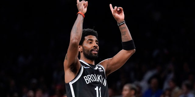 Brooklyn Nets' Kyrie Irving reacts after sinking the basket in the second half of the opening basketball game of the NBA Play-in Tournament with the Cleveland Cavaliers on Tuesday, April 12, 2022 in New York.