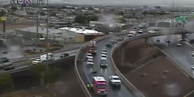 A Las Vegas traffic officer was conducting a traffic stop when a vehicle reversed and struck him Friday.