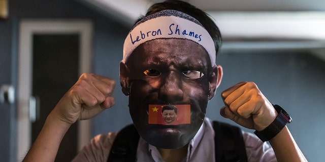 A demonstrator wears a LeBron James mask during the Face Mask Way event in Hong Kong, China, on Oct. 18, 2019.