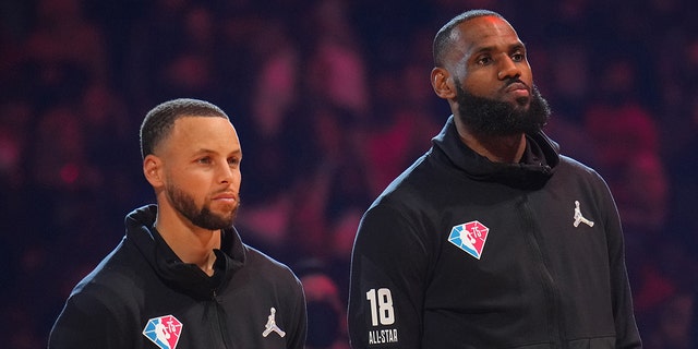 Stephen Curry and LeBron James of Team LeBron are introduced before the 2022 NBA All-Star Game Feb. 20, 2022, at Rocket Mortgage FieldHouse in Cleveland.
