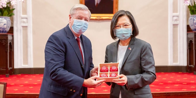 In this photo released by the Taiwan Presidential Office, Sen. Lindsey Graham, R-S.C., left, and Taiwan's President Tsai Ing-wen, right, pose for a photo during a meeting at the Presidential Office in Taipei, Taiwan, April 15, 2022.