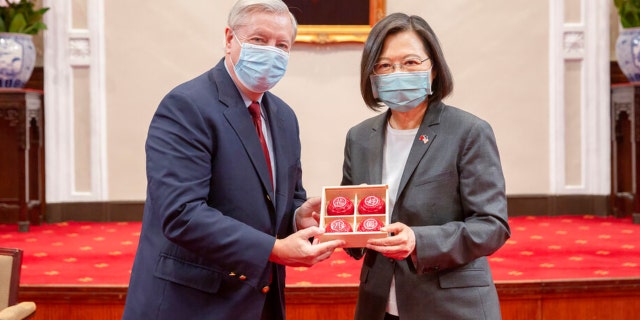 Senator Lindsey Graham, R.S.C., left, and Taiwanese President Tsai Ing-wen, right, pose for a photo during a meeting at the presidential office in Taipei, Taiwan, Friday, April 15, 2022.