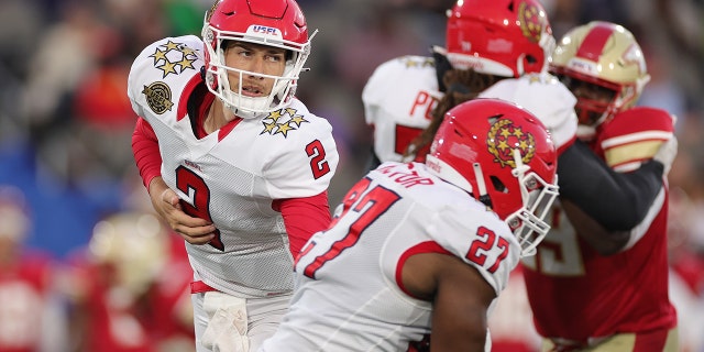 Luis Perez of New Jersey Generals hands the ball off to teammate Darius Victor against the Birmingham Stallions at Protective Stadium on April 16, 2022, in Birmingham, Alabama.