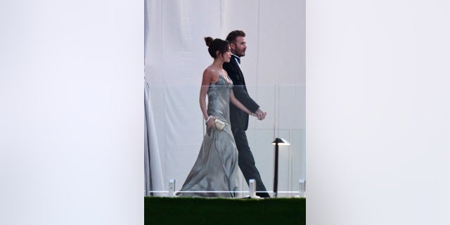 David Beckham and his wife Victoria Beckham enter the dinner tent after their son Brooklyn Beckham married Nicola Peltz in Palm Beach, Florida.