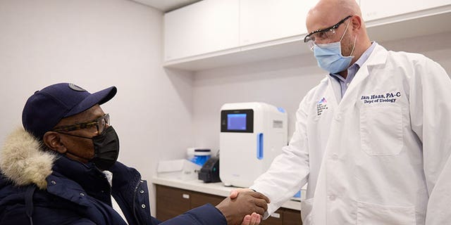 A doctor in Mount Sinai Hospital Service's new mobile cancer unit shakes the hand of a patient