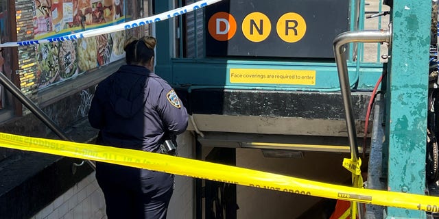 An MTA Officer enters a closed off subway entrance