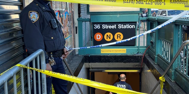 MTA Officer stands outside closed off subway