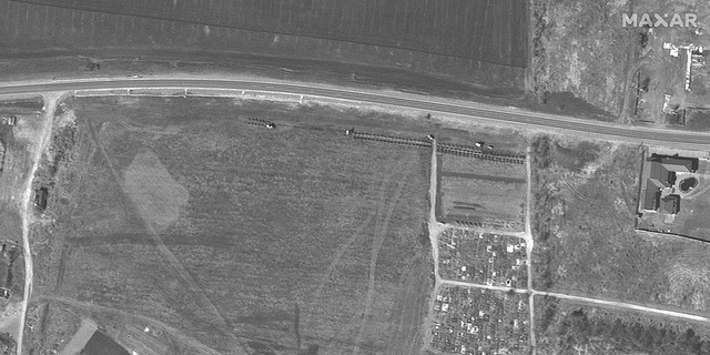 On March 26, the first rows of graves start to appear. (Satellite image ©2022 Maxar Technologies)