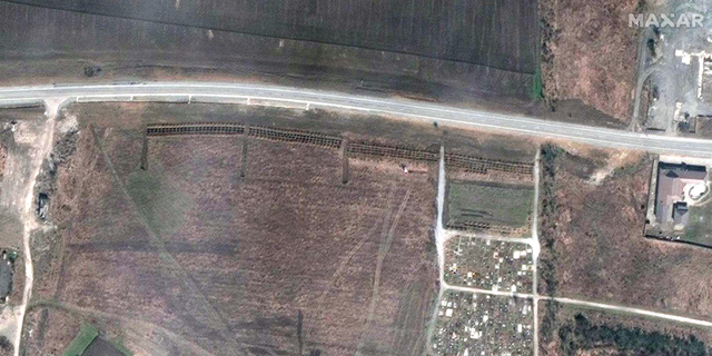 On April 3, columns of tombs can be seen at the site in Manhush, Ukraine.  (Satellite image ©2022 Maxar Technologies)