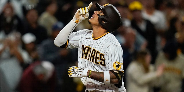 San Diego Padres' Manny Machado reacts after hitting two-run home run during the seventh inning of a baseball game against the Atlanta Braves, Thursday, April 14, 2022, in San Diego.