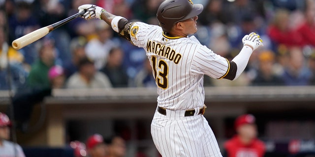 The San Diego Padres' Manny Machado hits a two-run home run during the first inning of a game against the Cincinnati Reds at Petco Park in San Diego on April 19, 2022.