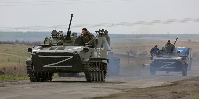 Russian military vehicles move on a highway in an area controlled by Russian-backed separatist forces near Mariupol, Ukraine in late April.