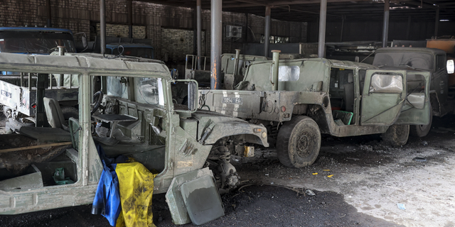 Damaged Ukrainian army military vehicles with a Ukrainian national flag are seen at the partly destroyed Illich Iron &amp; Steel Works Metallurgical Plant, in an area controlled by Russian-backed separatist forces in Mariupol, Ukraine, on Monday.