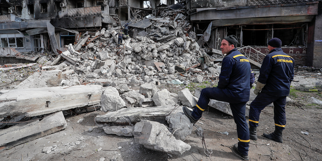 Emergency workers remove debris of a building destroyed in the course of the Ukraine-Russia conflict in Mariupol on Sunday. 
