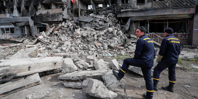 Emergency workers remove debris of a building destroyed in the course of the Ukraine-Russia conflict in Mariupol on Sunday. 