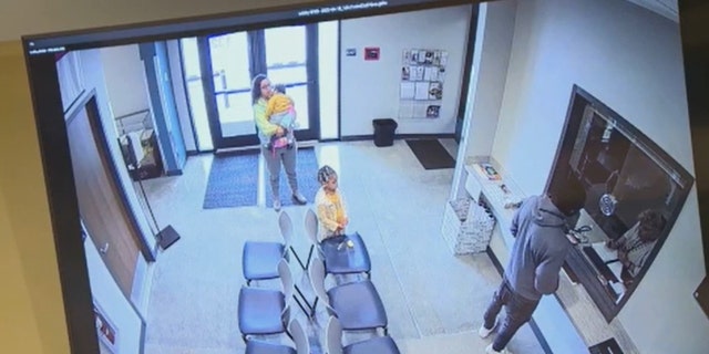 Meeks, Brown and their two children visiting the Davie County Sheriff's Office. 
