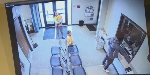 Meeks, Brown and their two children visiting the Davie County Sheriff's Office.