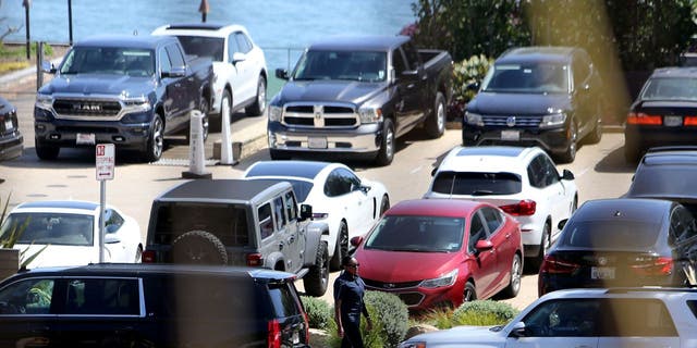 Secret Service agent stands outside car outside Nobu Restaurant in Malibu, CA