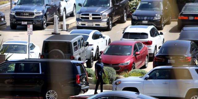Secret Service agent stands outside car outside Nobu Restaurant in Malibu, CA