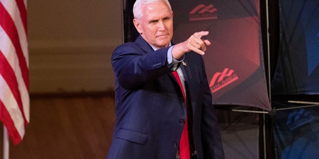 Former Vice President Mike Pence points as he arrives to speak at a campus lecture hosted by Young Americans for Freedom at the University of Virginia in Charlottesville, Virginia, April 12, 2022. 