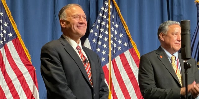 Former Secretary of State Mike Pompeo (left) is joined at the annual Lincoln-Reagan fundraising dinner by county chair and RNC member Chris Ager, in Manchester, New Hampshire, on April 7, 2022