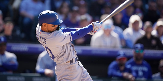 Los Angeles Dodgers' Mookie Betts connects for an RBI-double off Colorado Rockies starting pitcher Kyle Freeland on April 8, 2022, in Denver.