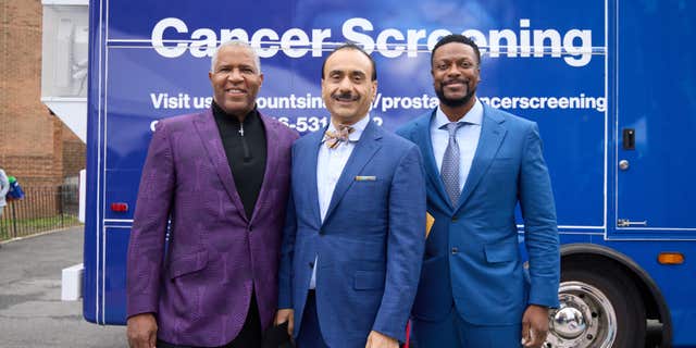 Members of Mt. Sinai Hospital Service's new mobile cancer unit pose in front of the bus