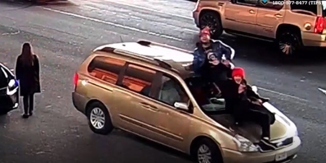 Video shows some suspects on the roof of the victim's vehicle.