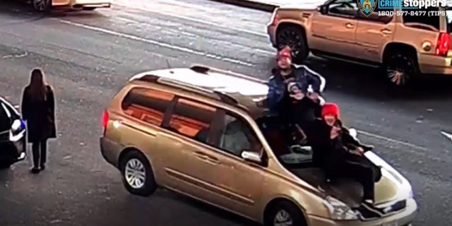 Video shows some suspects on the roof of the victim's vehicle.