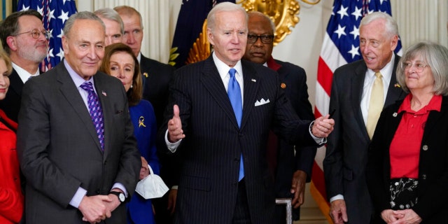 President Joe Biden gestures after signing the Postal Service Reform Act of 2022 in the State Dining Room at the White House