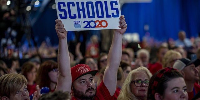 An attendee holds a sign that reads "Strong Public Schools 2020" during the National Education Association (NEA) #StrongPublicSchools Presidential Forum in Houston, July 5, 2019. (Sergio Flores/Bloomberg via Getty Images)