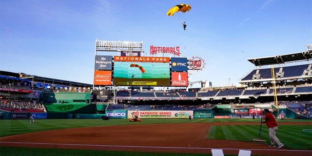 The U.S. Army Parachute Team the Golden Knights descend into National Park before a baseball game between the Washington Nationals and the Arizona Diamondbacks Wednesday, April 20, 2022, in Washington.