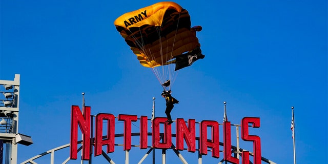 The U.S. Army Parachute Team the Golden Knights descend into National Park before a baseball game between the Washington Nationals and the Arizona Diamondbacks Wednesday, April 20, 2022, in Washington. 